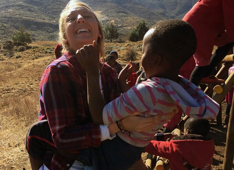 Student holding orphan